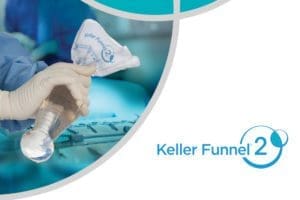 Plastic surgeon using the keller funnel to insert a breast implant.